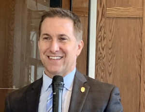 A picture of State Attorney Dave Aronberg speaking in front of a microphone